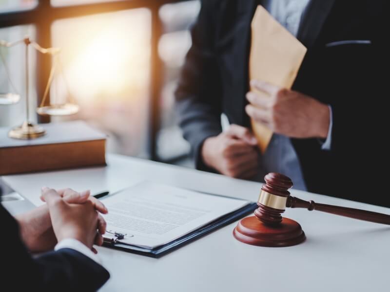 Lawyer and client discussing case details in a courtroom setting