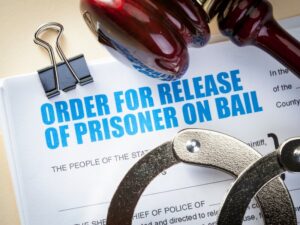 Order for release of prisoner on bail with handcuffs and gavel on the document.