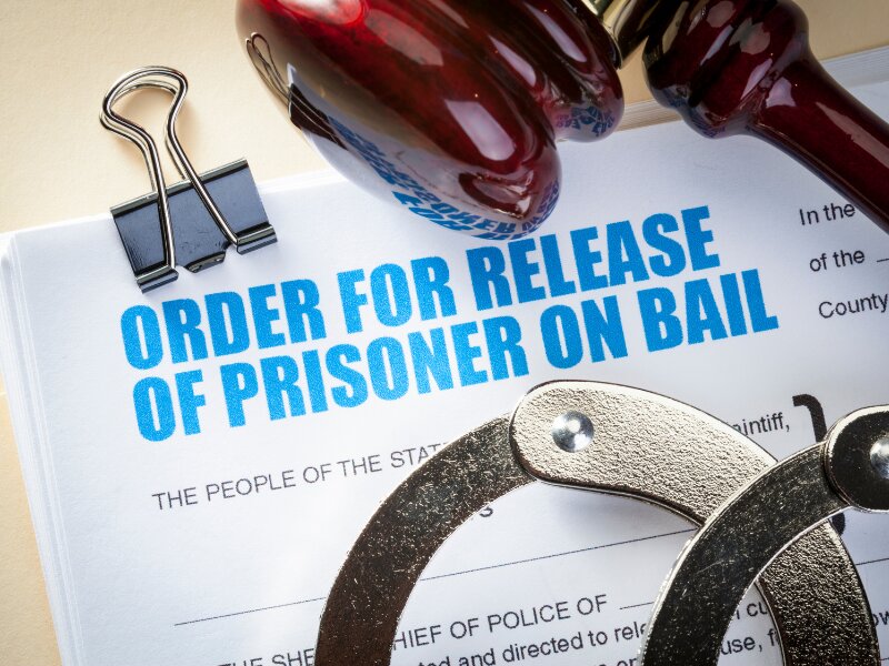 Order for release of prisoner on bail with handcuffs and gavel on the document.